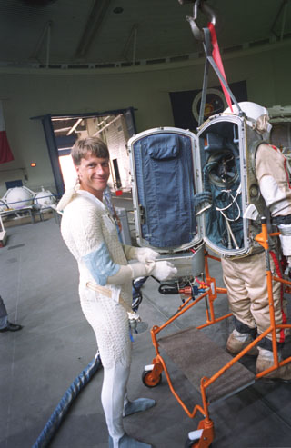 Foale preparing to enter the open back of the Russian Orlan Suit